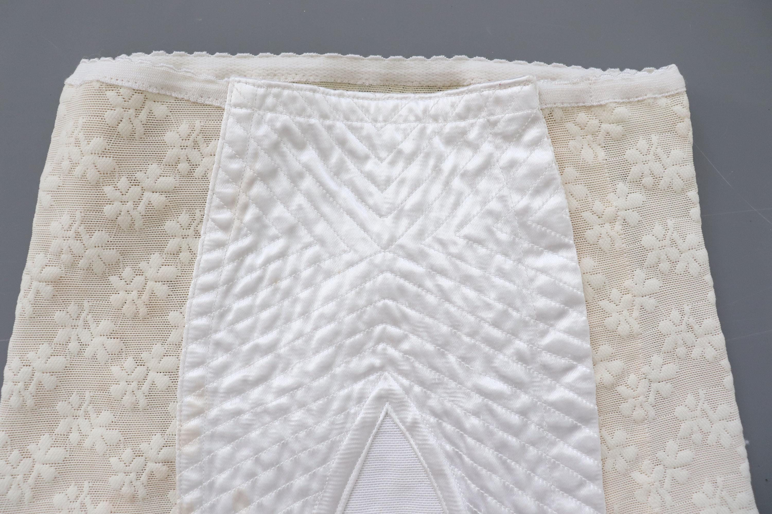 C1950s vintage cream embossed powernet and satin roll on corset girdle. 20-23" Waist